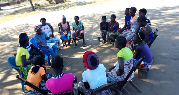 Isabel Feliz (with capulana scarf) conducting counseling session for teenagers