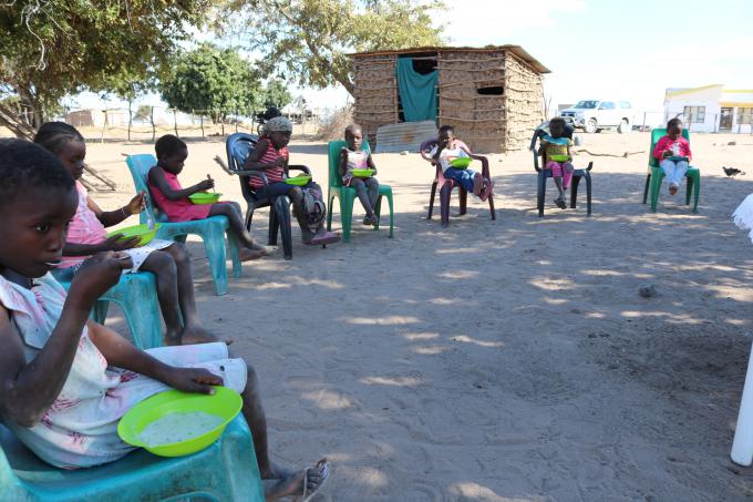 Children in Pumbe community, in Guijá, enjoy the fortified porridge made with local products