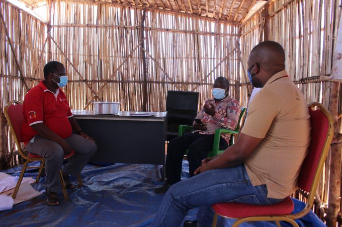 Save the Children staff interacting with the head of the Corrane Administrative Post