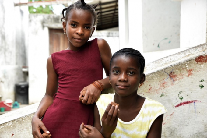 Elina (11), left, and her best friend Faria (12), right, near their homes in Cabo Delgado region in northern Mozambique. Elina’s house was badly damaged and Faria’s house was completely destroyed when Cyclone Kenneth hit her village in April 2019. 