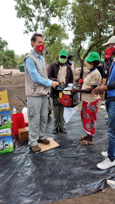 Chance Briggs delivers a motor pump to a member of the community to boost agricultural production